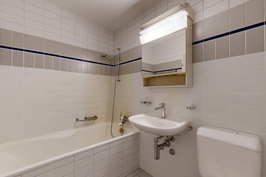 full bath with tile walls and tiled shower / bath
