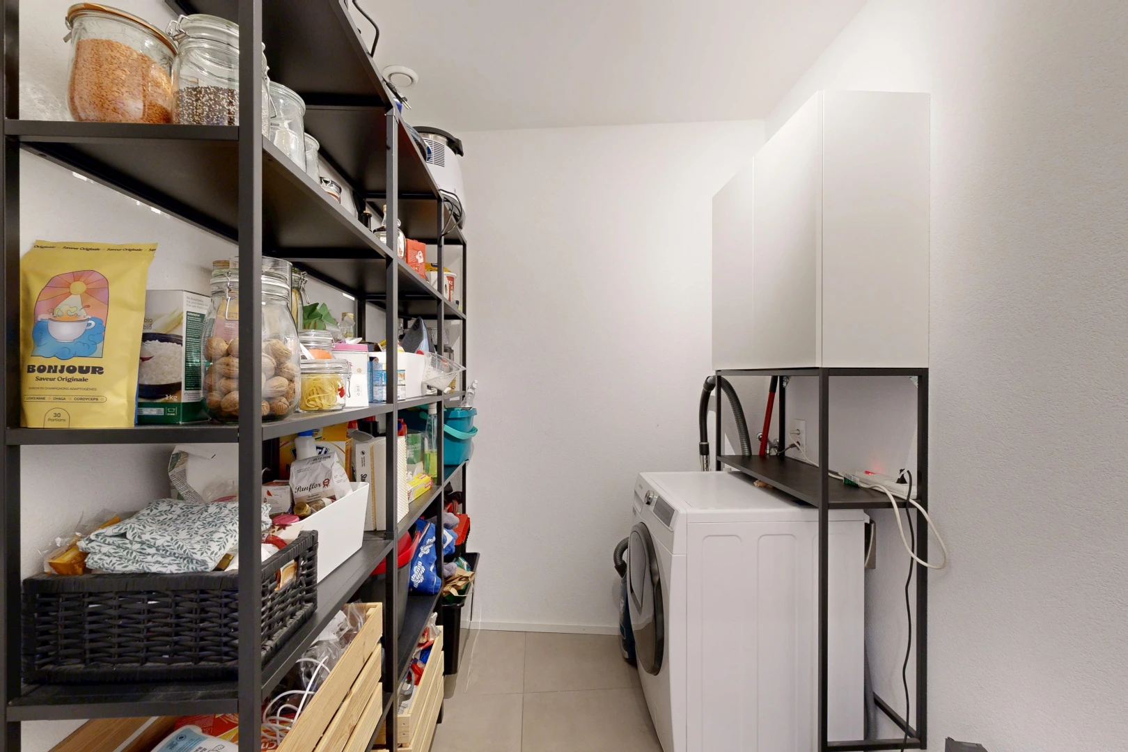 laundry area with washer / clothes dryer and light tile patterned floors