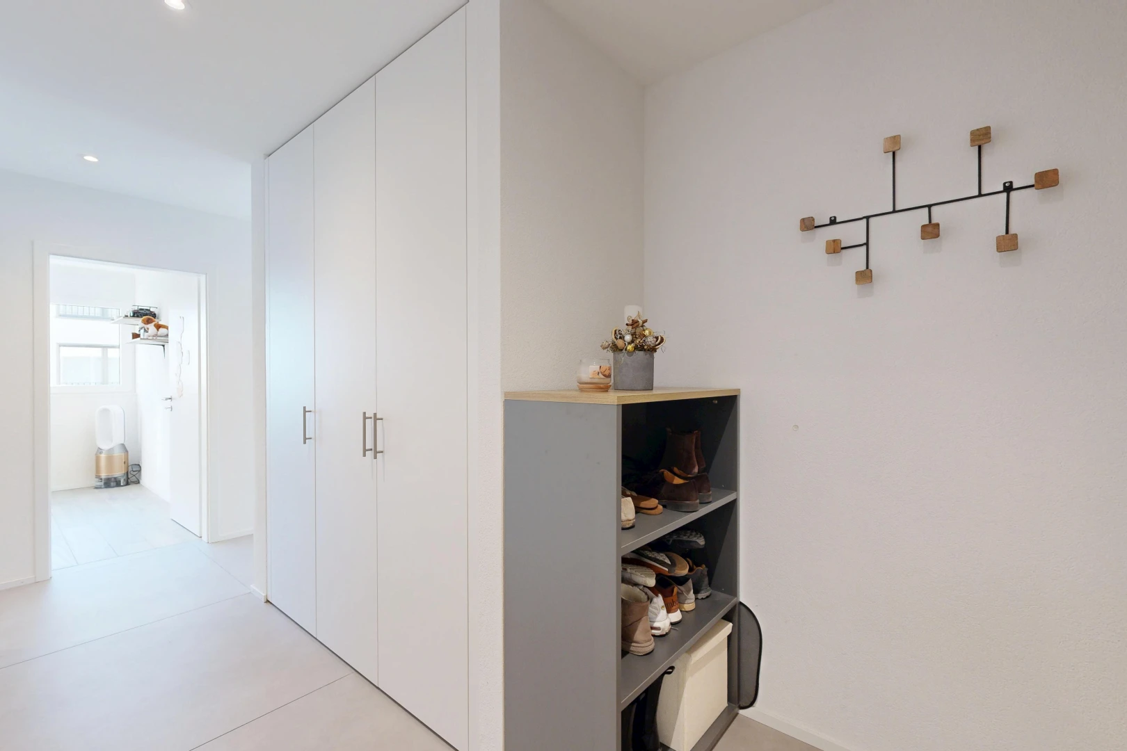corridor with recessed lighting and a closet