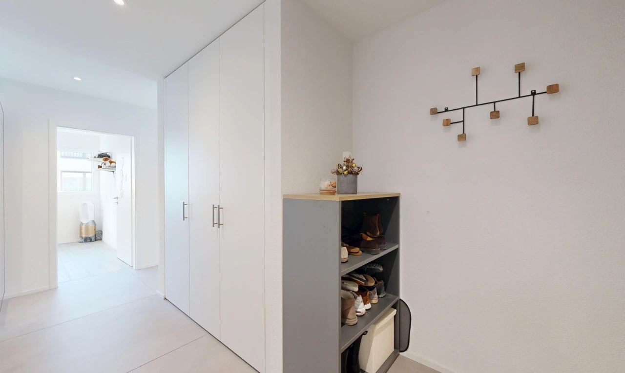 corridor with recessed lighting and a closet