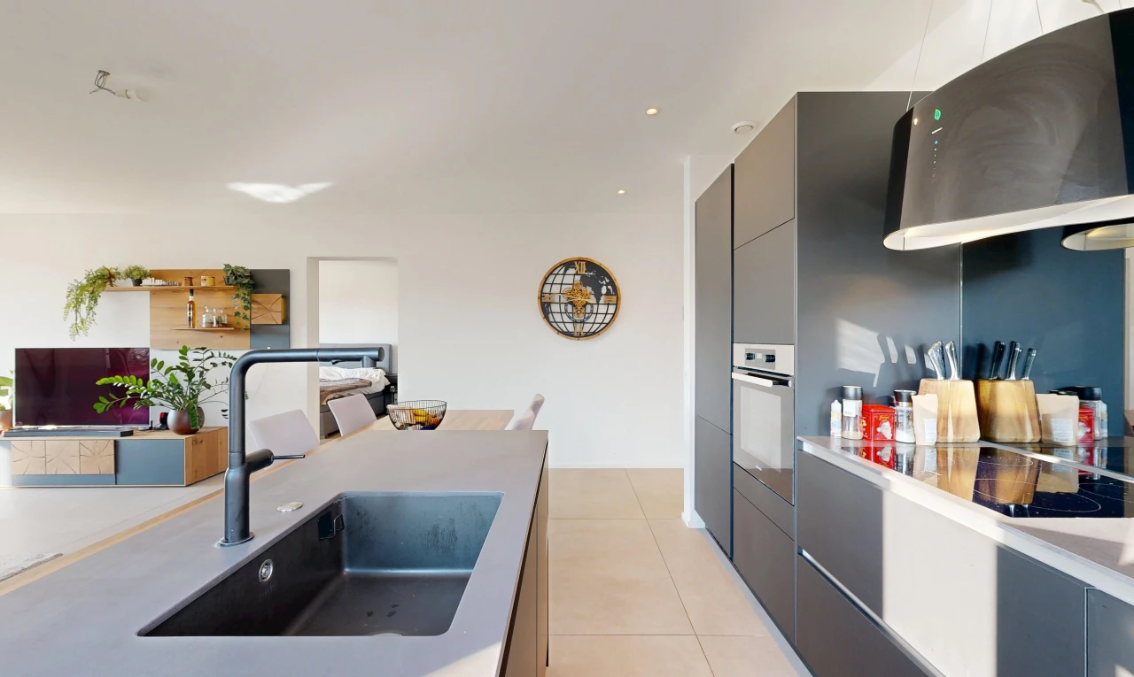 kitchen featuring modern cabinets, oven, light countertops, and light tile patterned floors