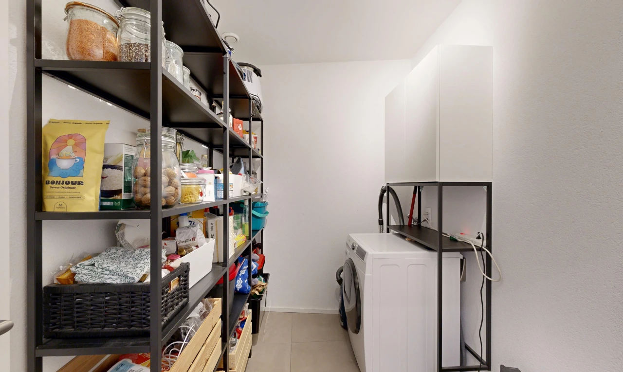 laundry area with washer / clothes dryer and light tile patterned floors