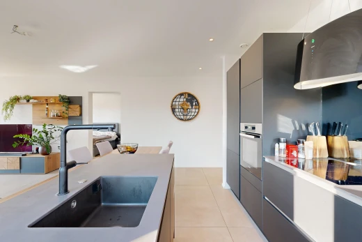 kitchen featuring modern cabinets, oven, light countertops, and light tile patterned floors