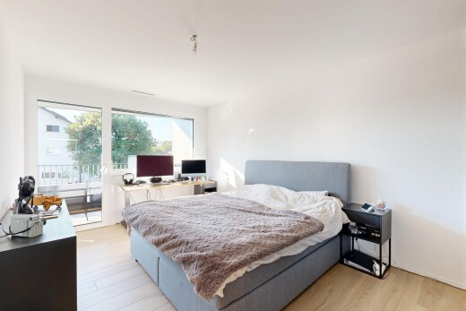 chambre avec accès à l'extérieur, cloison sèche, drywall, sol en finition bois, et wood finish floor