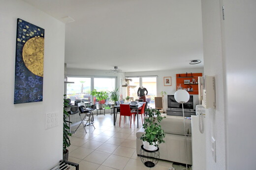 living / dining room with light tile patterned floors and a ceiling fan