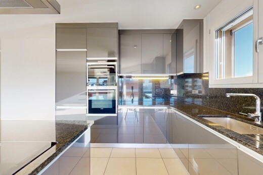 cuisine avec plans de travail en pierre, stone countertops, dark countertops, four double, et évier