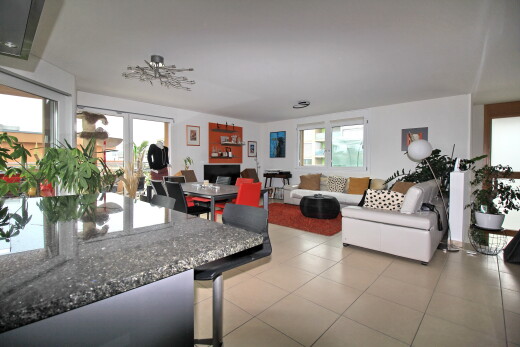 living area featuring plenty of natural light and light tile patterned floors