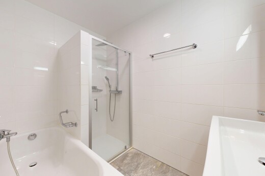 full bathroom featuring a bath and a shower stall