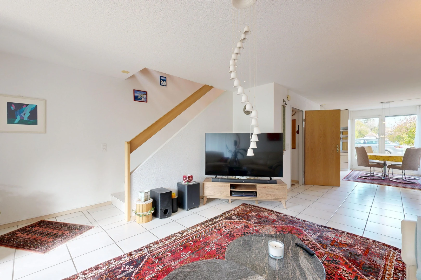 living room featuring stairway and light tile patterned floors