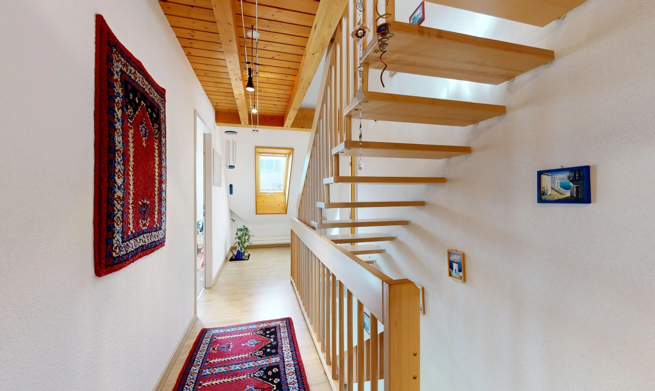 staircase with wooden ceiling and light wood-style floors