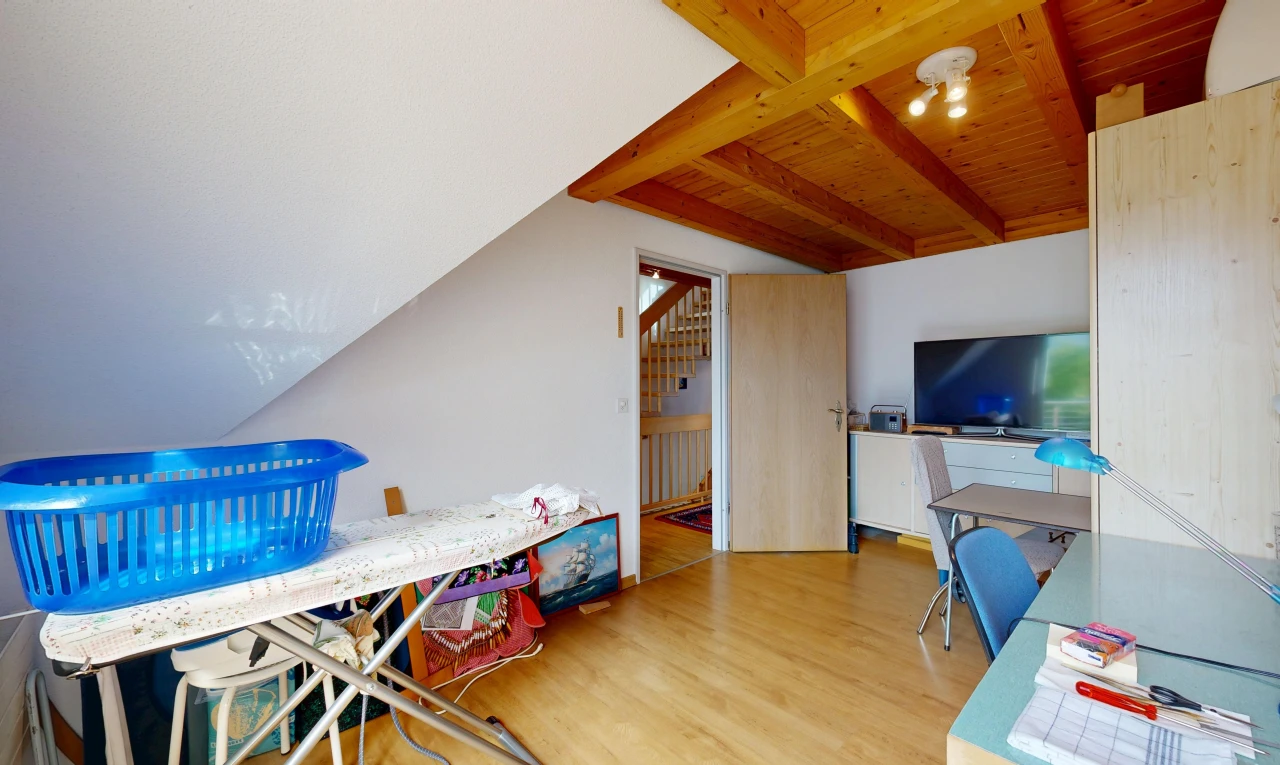 room featuring light wood-style floors and beam ceiling