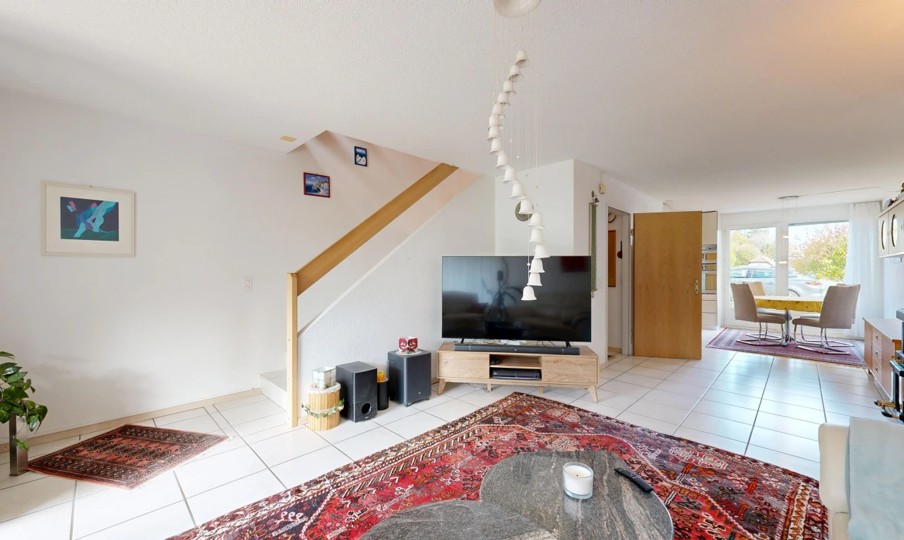 living room featuring stairway and light tile patterned floors