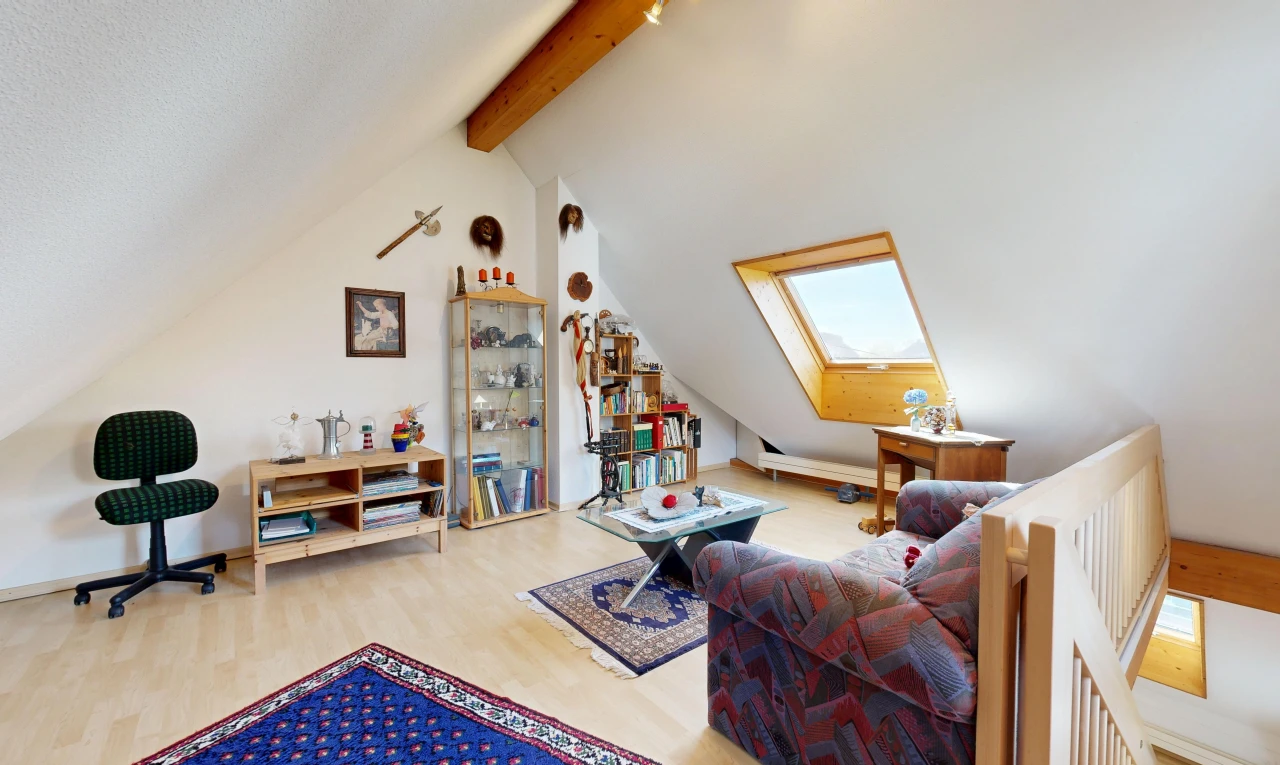 living room with a skylight, beamed ceiling, and light wood-style flooring
