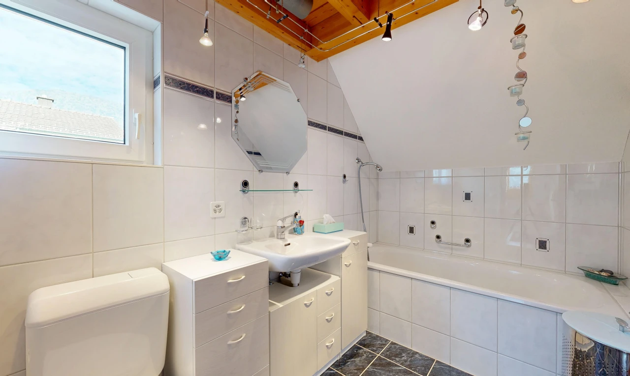 full bath featuring tile walls, vanity, and dark tile patterned floors