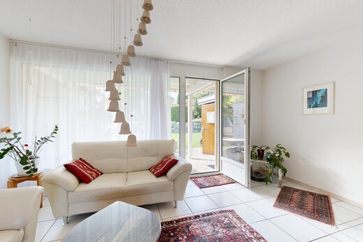 living room featuring access to outside and light tile patterned floors
