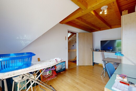 room featuring light wood-style floors and beam ceiling