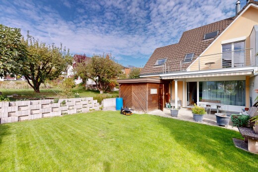 view of home with a yard and a patio
