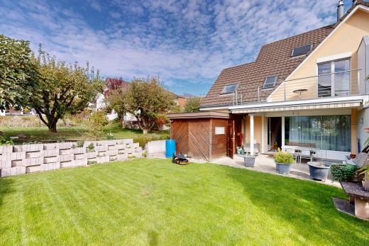 view of home with a yard and a patio