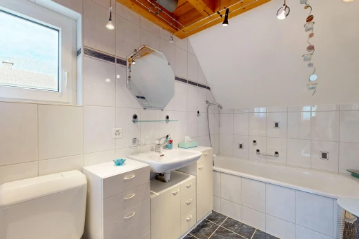 full bath featuring tile walls, vanity, and dark tile patterned floors