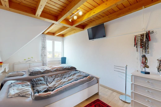room / bedroom featuring a wooden ceiling with exposed beams and light wood-style floors