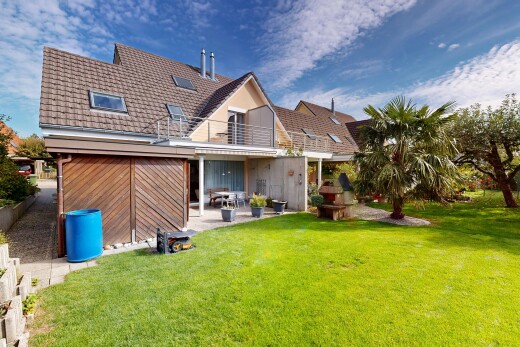 outdoor house with a lawn, a patio area, and a balcony