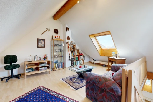 living room with a skylight, beamed ceiling, and light wood-style flooring