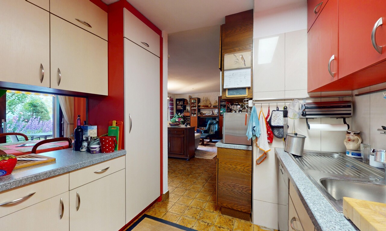 kitchen with light countertops, white dishwasher, and backsplash