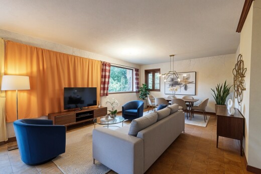 living room featuring a chandelier and tile patterned flooring