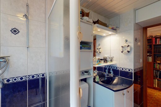full bath with tile walls, vanity, tiled shower, tile patterned flooring, and tasteful backsplash