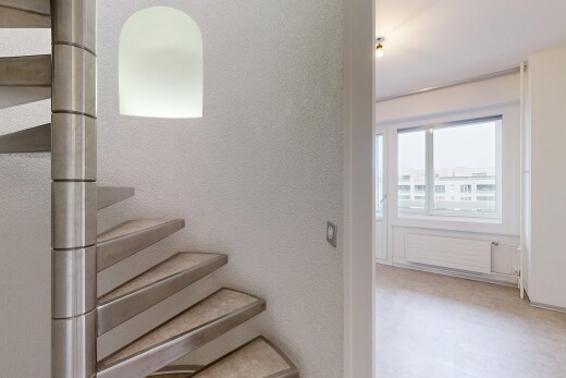 stairs with radiator heating unit and a textured wall