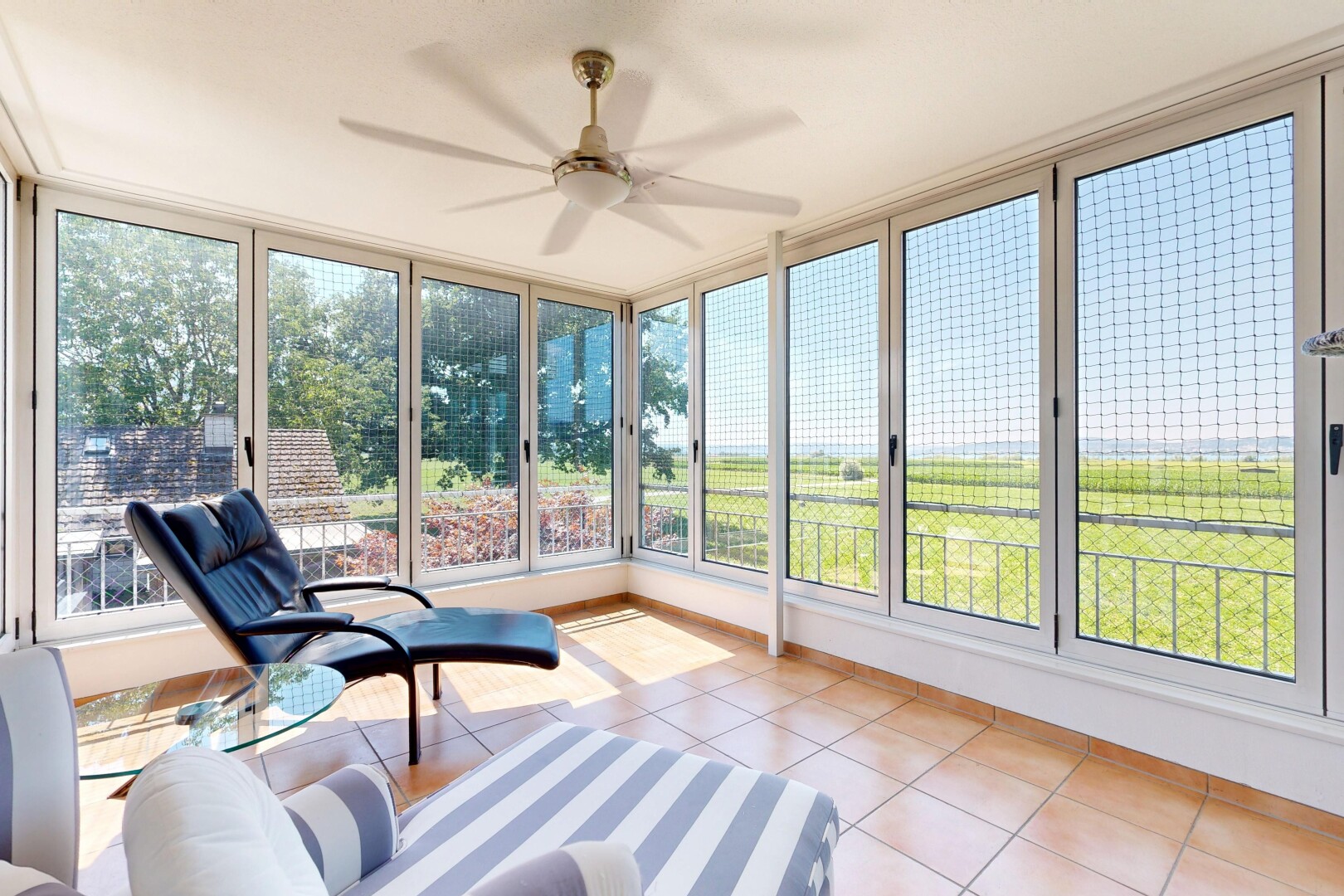 living room featuring a ceiling fan and light tile patterned flooring