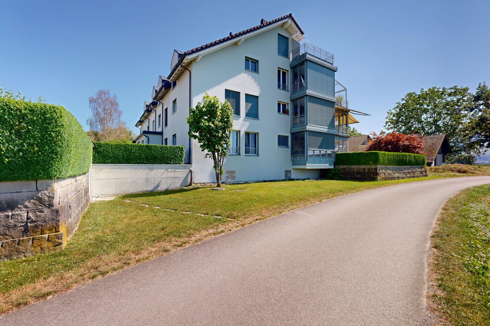 view of home with stucco siding and a lawn
