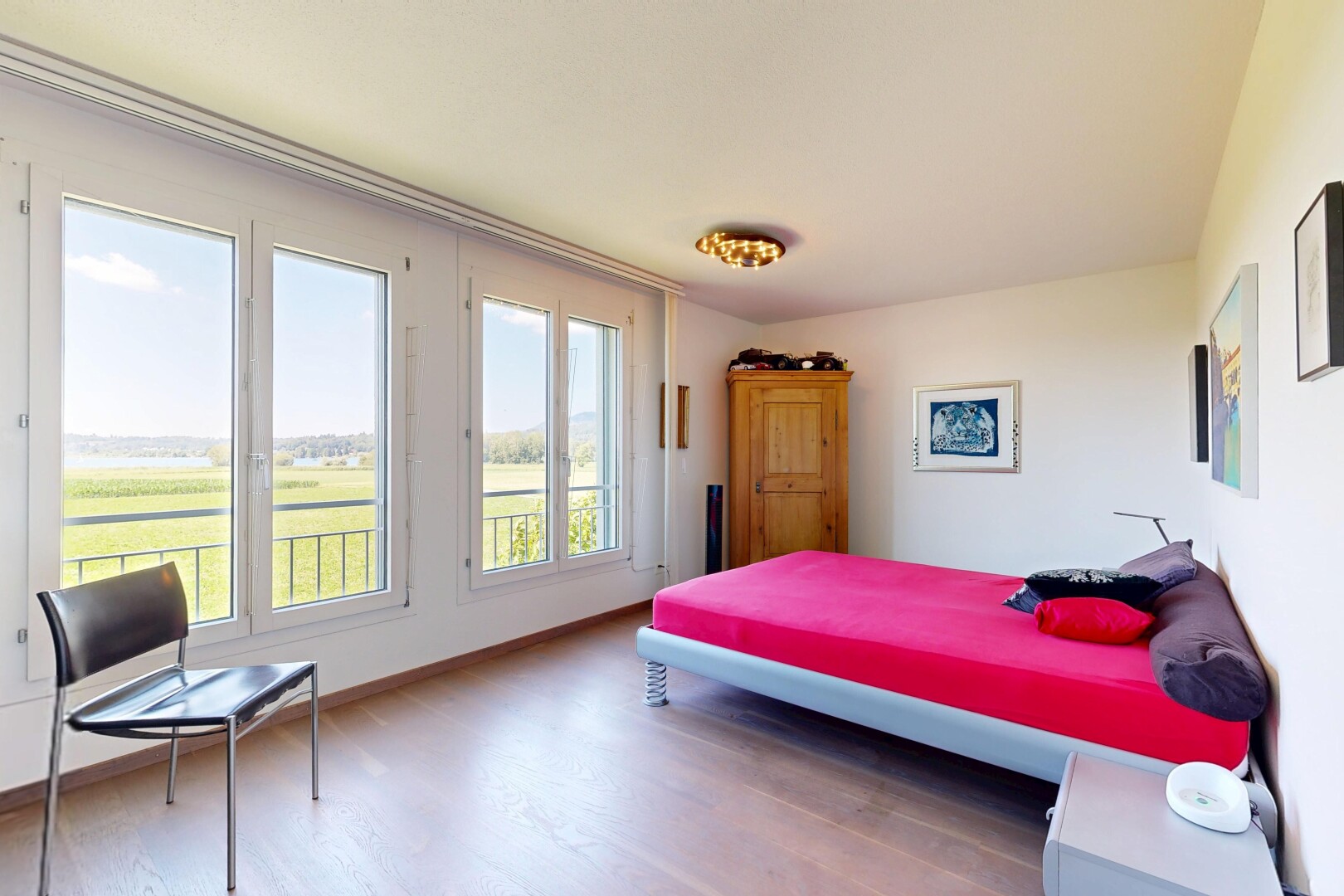 room / bedroom featuring light wood-style flooring and baseboards