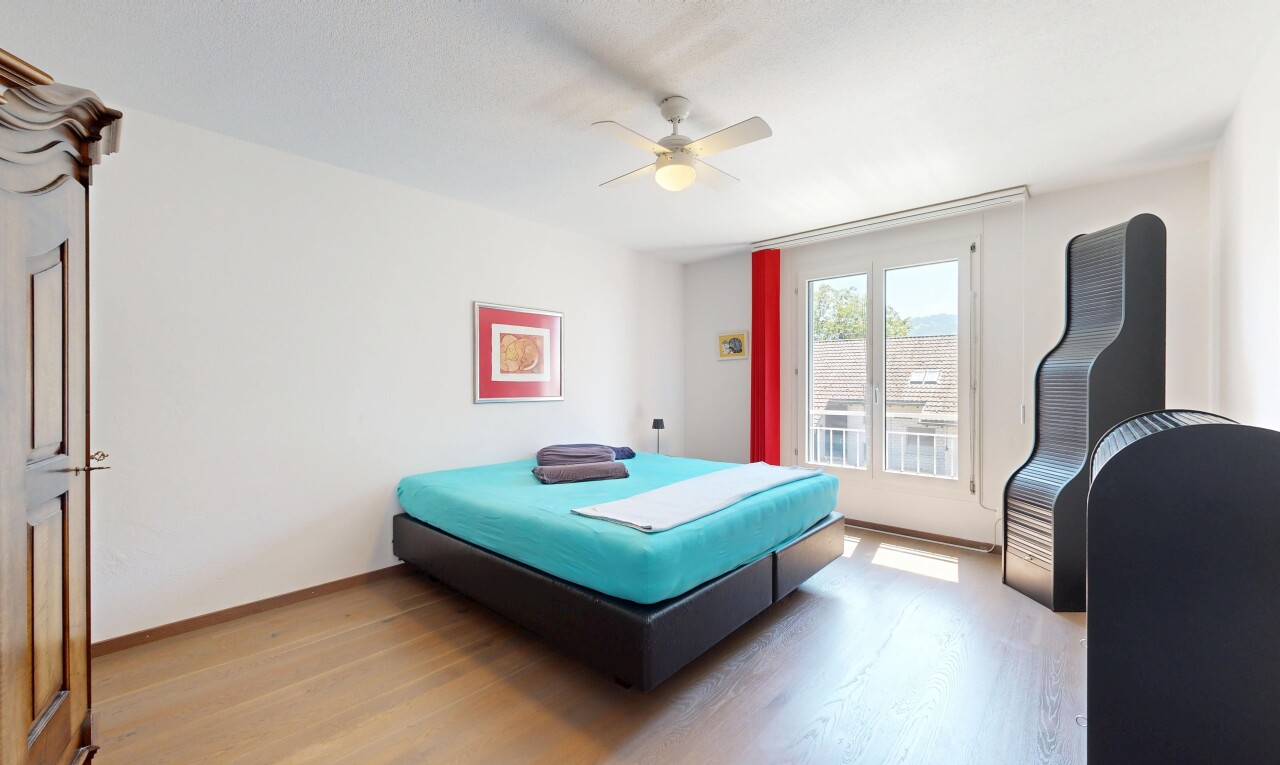room / bedroom featuring light wood finished floors and ceiling fan