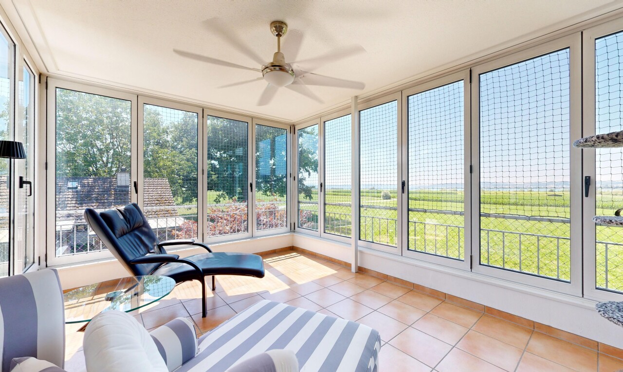 living room featuring a ceiling fan and light tile patterned flooring