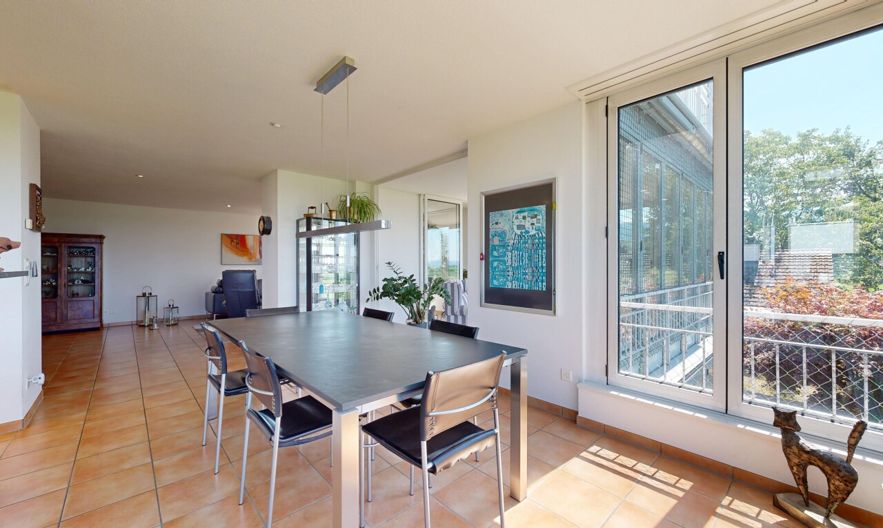 dining room with light tile patterned floors and baseboards