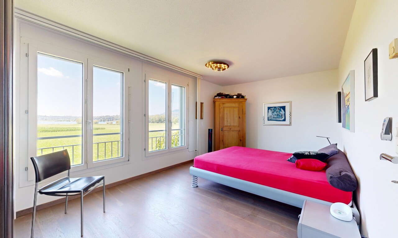 room / bedroom featuring light wood-style flooring and baseboards