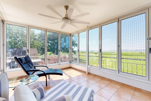 living room featuring a ceiling fan and light tile patterned flooring