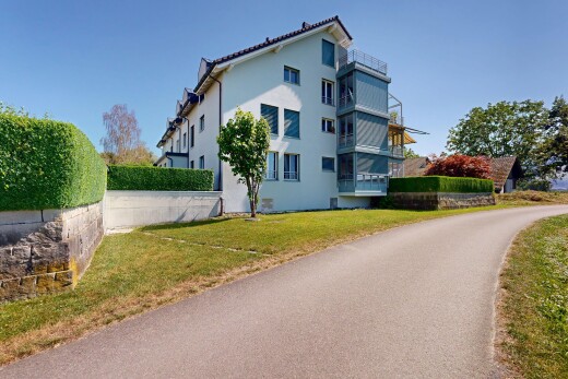 view of home with stucco siding and a lawn