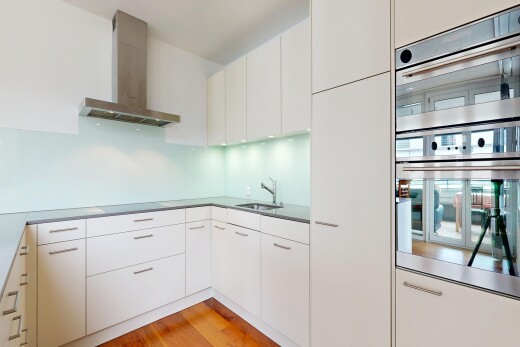 küche mit dunstabzugshaube, holzfußboden, wood finish floor, doppel backofen, und light floor