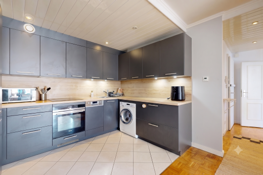 kitchen featuring light countertops, oven, washer / clothes dryer, recessed lighting, and modern cabinets