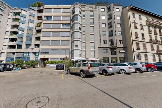 view of apartment building / complex with uncovered parking