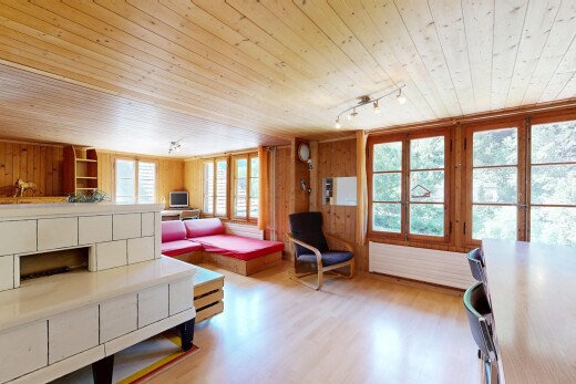 living area with wooden ceiling, wooden walls, light wood-style floors, and rail lighting
