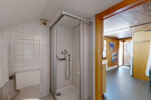 full bathroom featuring a shower stall and light tile patterned floors