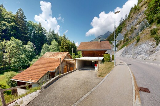 view of property featuring a tile roof