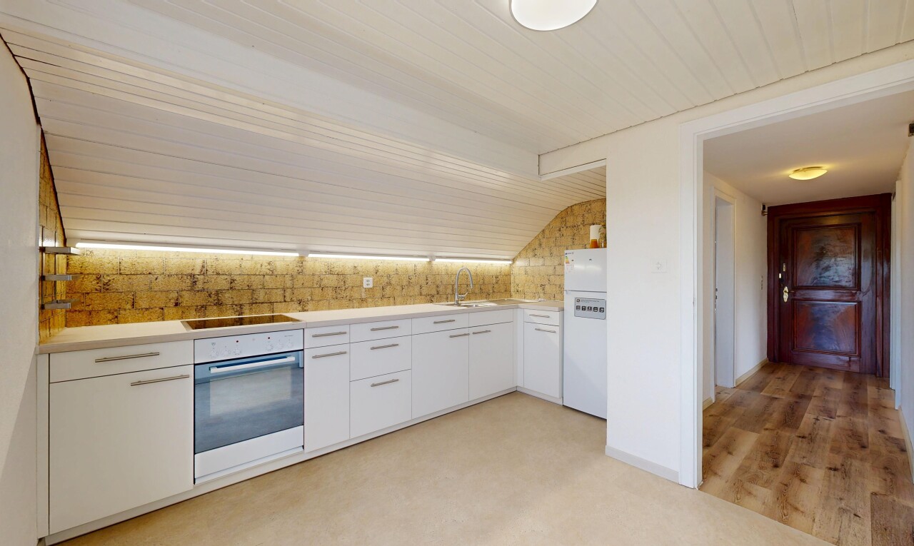 kitchen featuring light countertops, oven, white cabinetry, and freestanding refrigerator
