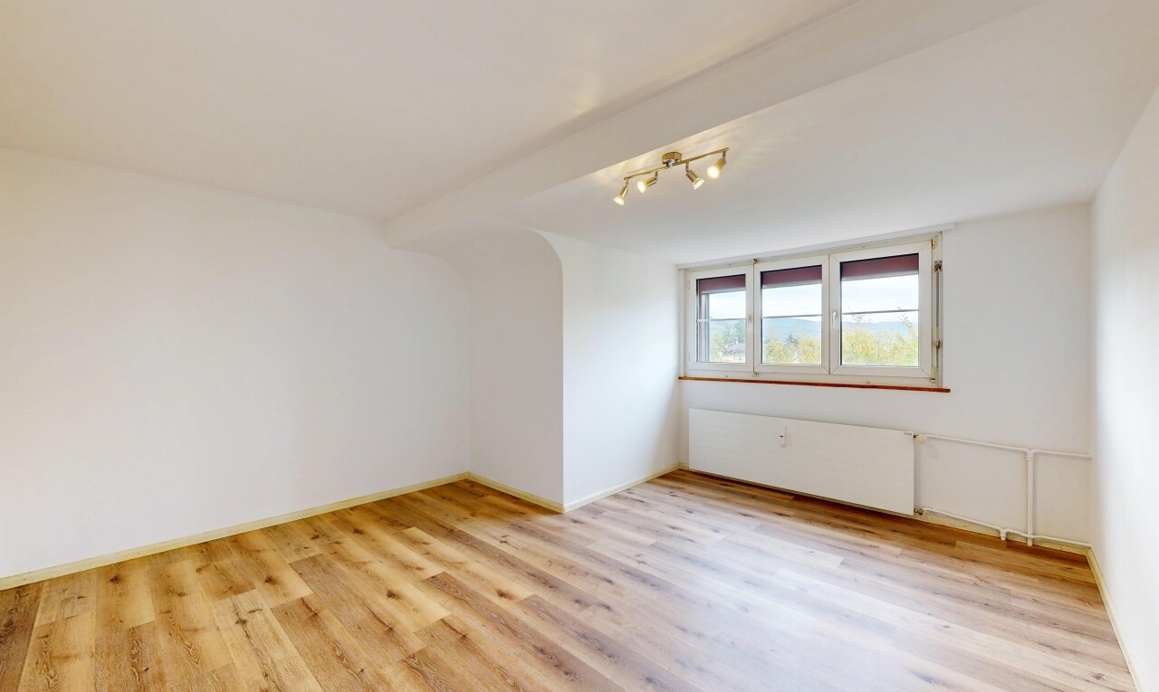 empty room with rail lighting and light wood-style floors