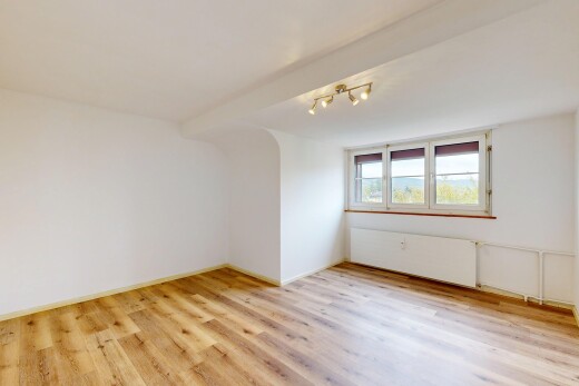 empty room with rail lighting and light wood-style floors
