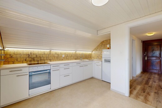 kitchen featuring light countertops, oven, white cabinetry, and freestanding refrigerator