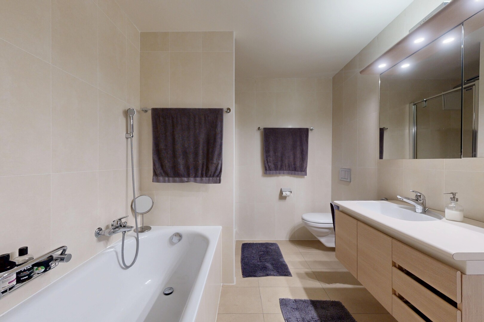full bath featuring tile walls, vanity, a tub, a shower, and light tile patterned floors